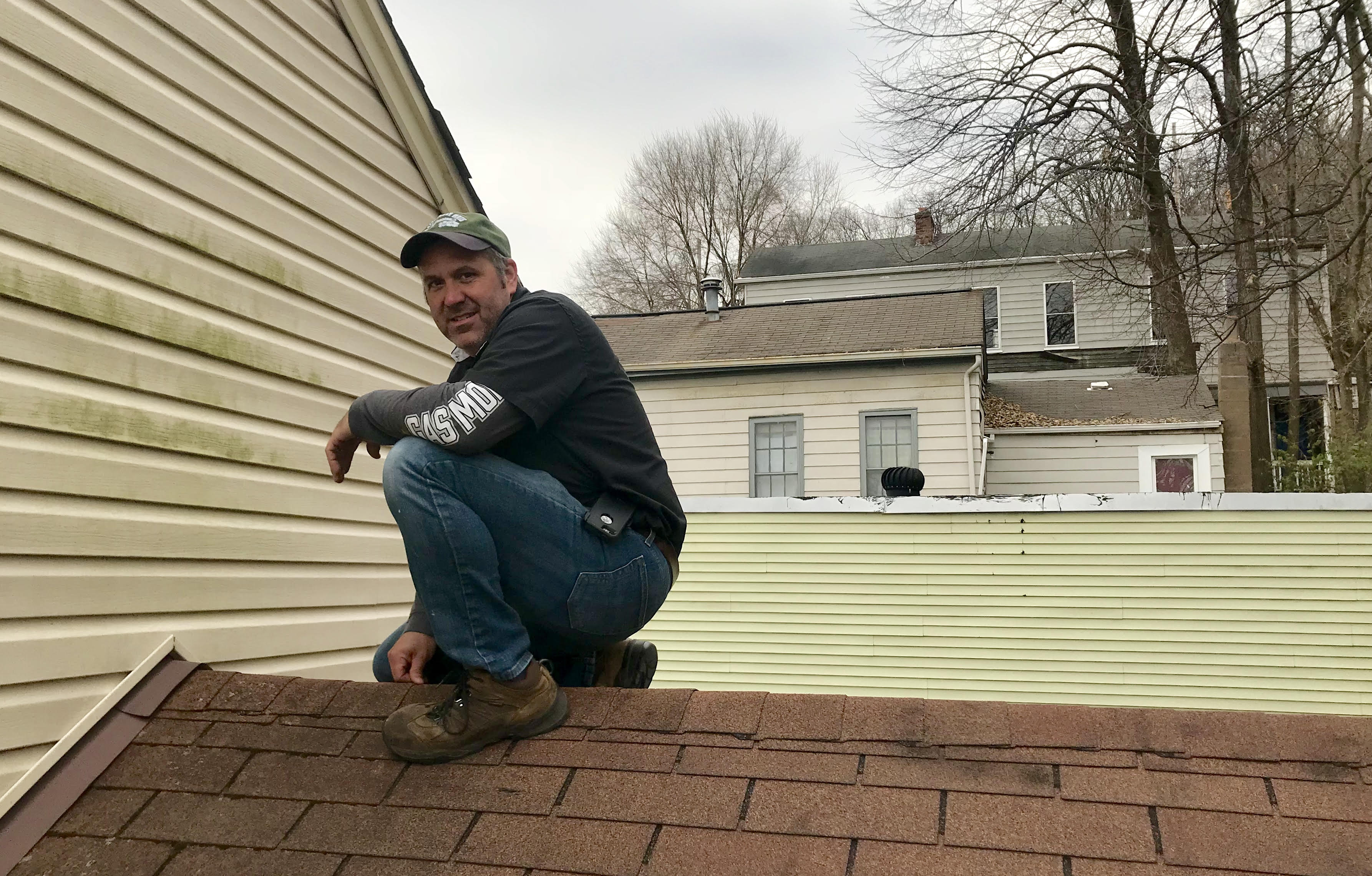 Wayne Mitchell of Assured Home Inspections inspecting the roof of a single family home