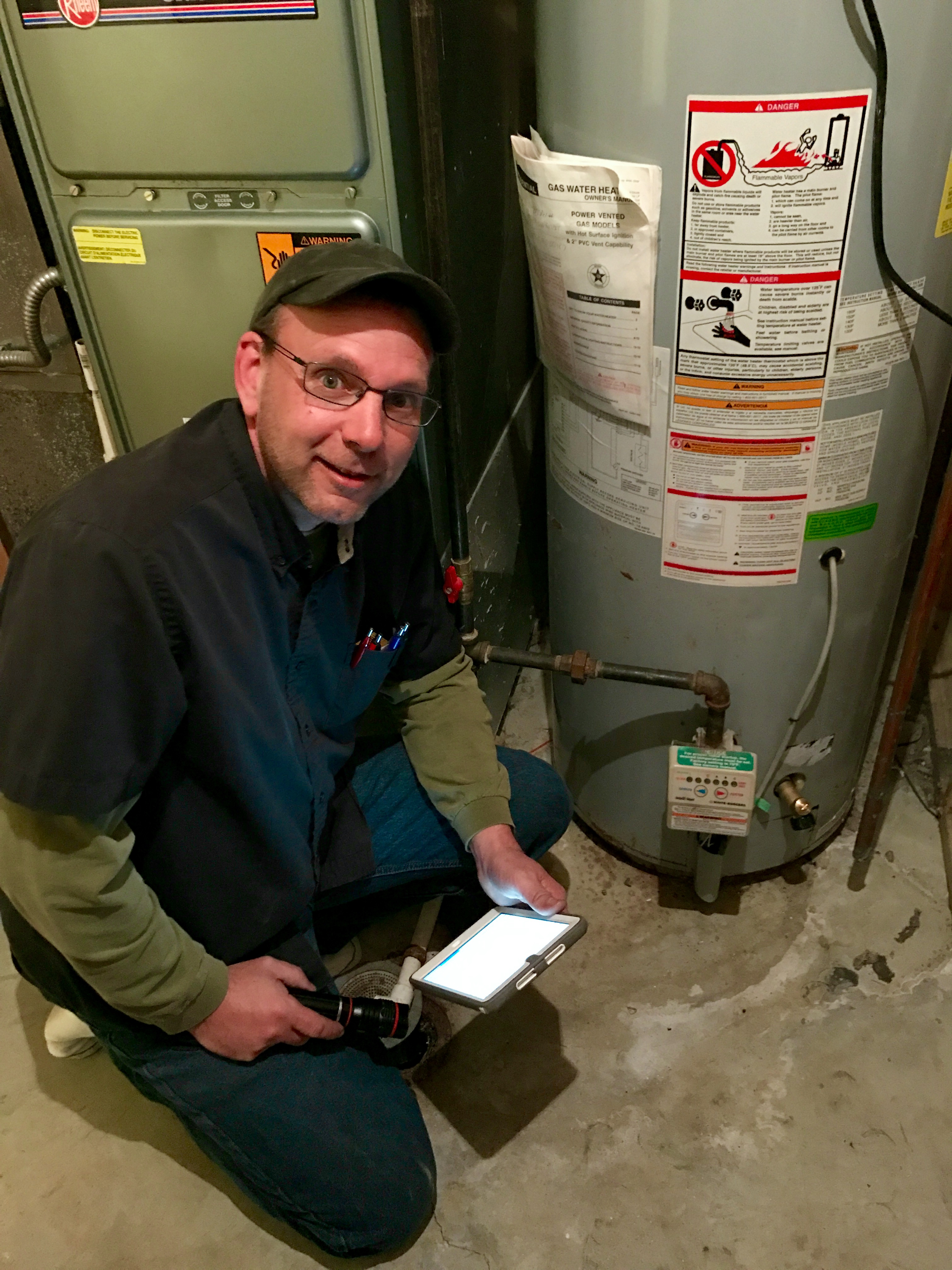 John Lawson of Assured Home Inspections inspecting the water heater of a single-family home in Northern Kentucky